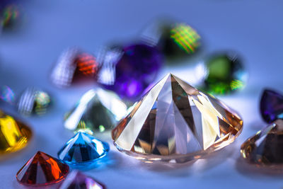 Close-up of multi colored diamonds on table 