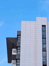 Low angle view of building against clear blue sky