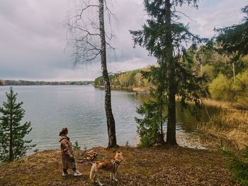 Dog standing by lake