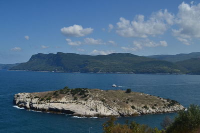Scenic view of sea and mountains against sky