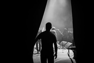 Rear view of silhouette man standing on stage