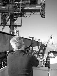 Rear view of man working at construction site