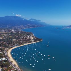 High angle view of sea and cityscape against sky