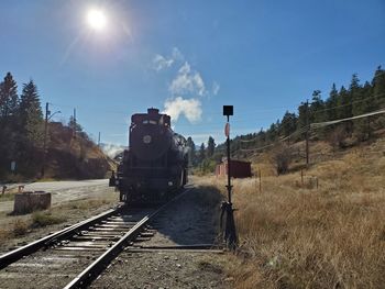 Train on railroad track against sky