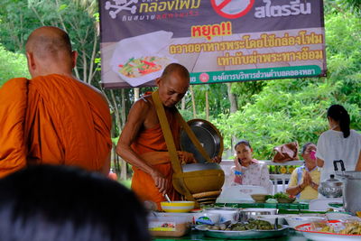 Rear view of people having food