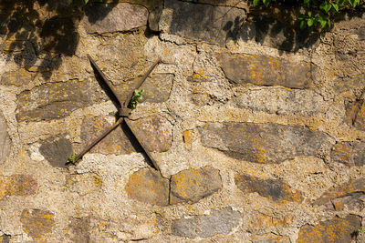 An old medieval stone wall as a background.