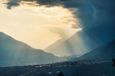 Scenic view of snowcapped mountains against sky during sunset