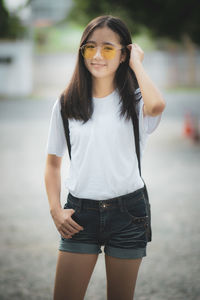 Cheerful young woman standing outdoors