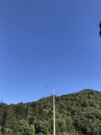 Low angle view of mountain against clear blue sky