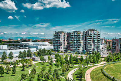 High angle view of road by buildings against sky