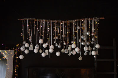 Close-up of illuminated lighting equipment against black background