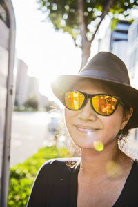 Woman with mirrored sunglasses looking at camera