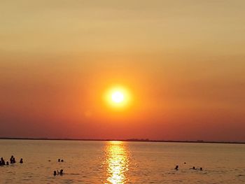 Scenic view of sea against orange sky