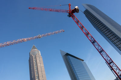 Low angle view of skyscrapers against clear blue sky