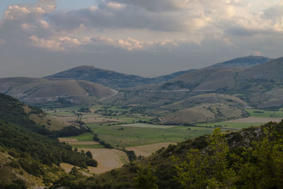 Scenic view of mountains against cloudy sky