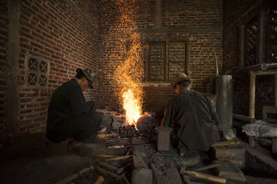 People sitting by bonfire