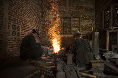 People sitting by fire