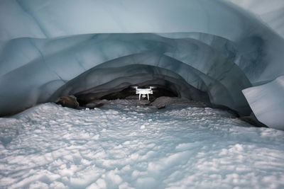 Drone flies deep into glacier cave to document climate change.