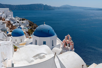 Panoramic view of sea and buildings against mountain