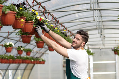 Young man working in greenhouse