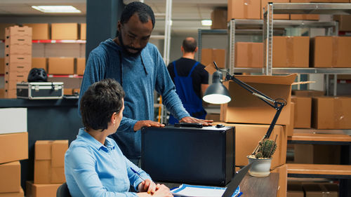 Rear view of man working at table