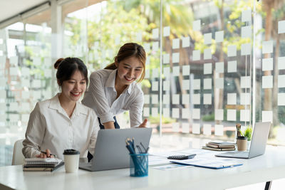 Smiling businesswomen working at office
