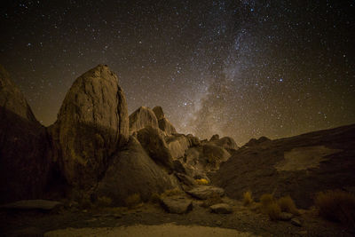 Scenic view of rock formations against sky at night