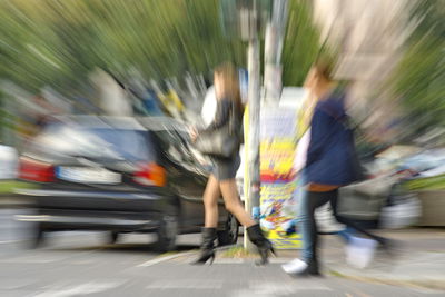 Blurred motion of man walking on road