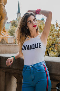 Young woman looking away while standing in city