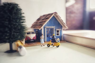 Close-up of toy car outside house against building