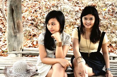 Portrait of smiling young woman sitting outdoors