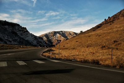 Road amidst mountains against sky