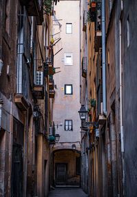 Alley amidst buildings in old medieval part of barcelona spain city. el born alley