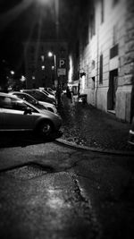 Close-up of cars on street in city