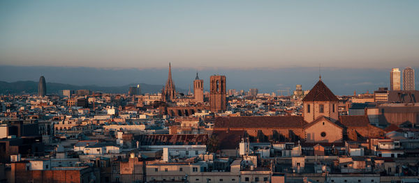 High angle view of city lit up at sunset