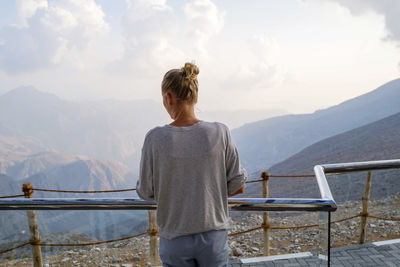 Woman overlooking dramatic mountain landscape