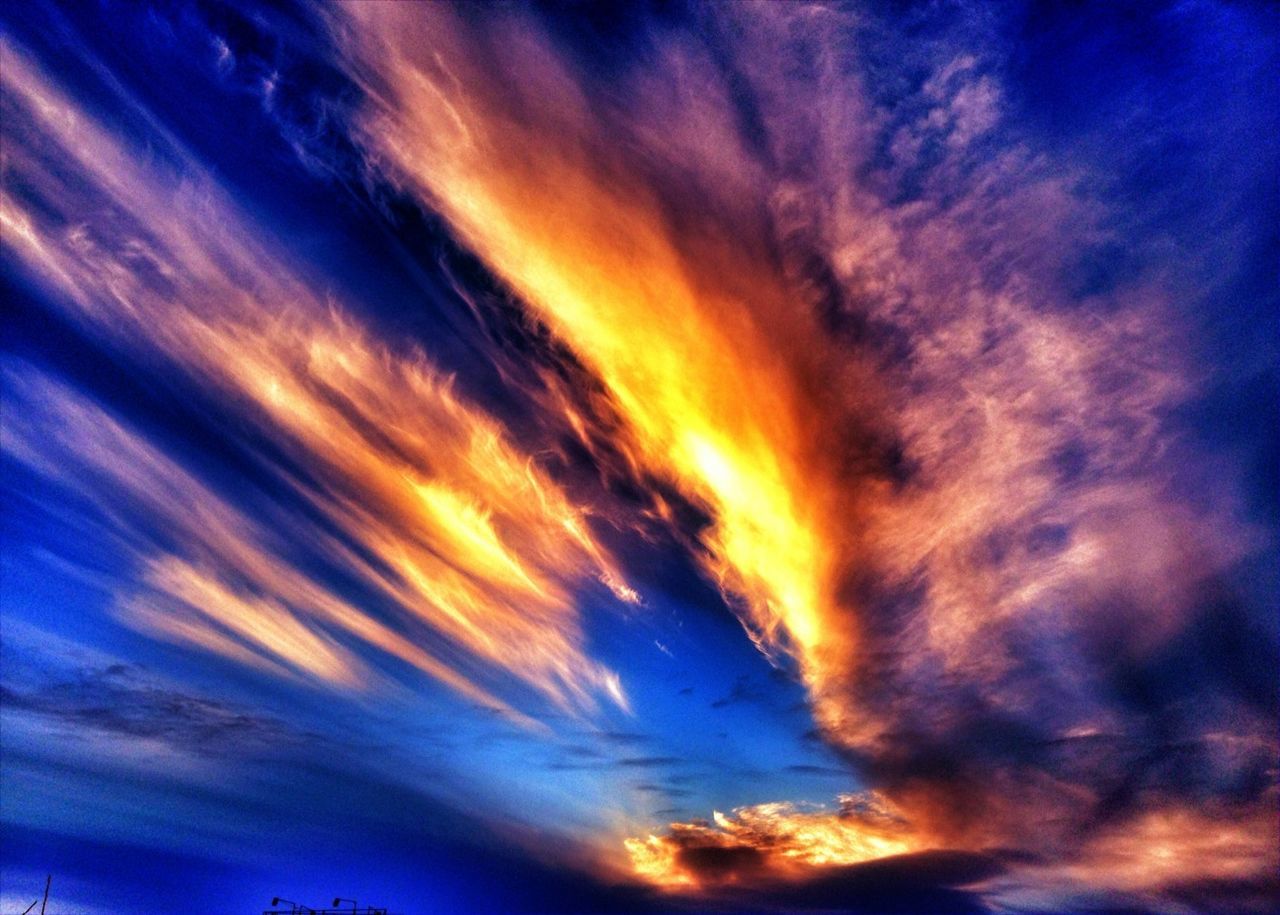 sky, cloud - sky, sunset, low angle view, beauty in nature, scenics, tranquility, dramatic sky, cloudy, tranquil scene, nature, cloudscape, cloud, orange color, blue, idyllic, majestic, sky only, moody sky, atmospheric mood