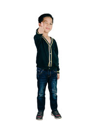 Portrait of boy standing against white background