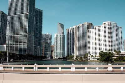 Modern buildings in city against clear sky