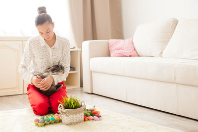 Young woman sitting on sofa at home