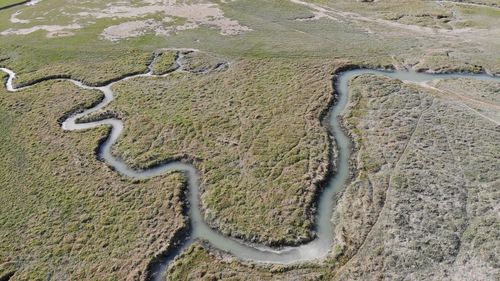 Aerial view of river passing amidst landscape