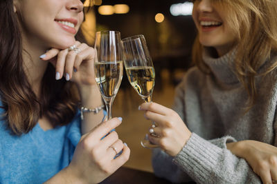 Close-up of a smiling young woman holding drink