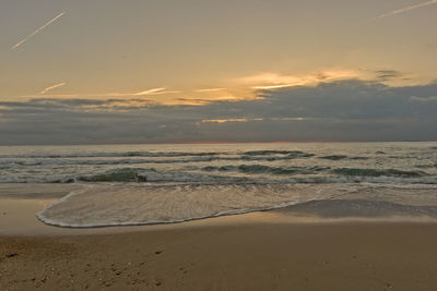 Scenic view of beach against sky during sunset