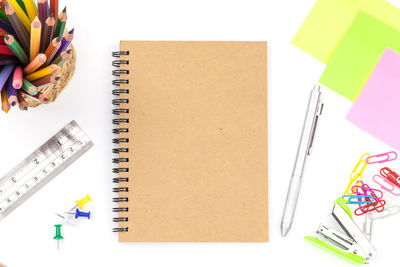 High angle view of office supplies on white background