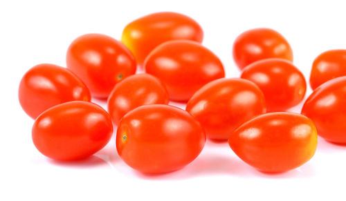 Close-up of tomatoes against white background