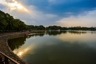 Scenic view of river against cloudy sky