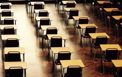 Empty chairs and tables in row