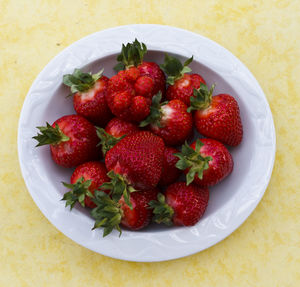 High angle view of strawberries in bowl on table