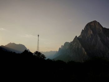 Scenic view of silhouette mountains against sky at sunset