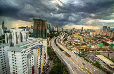 High angle view of street amidst buildings in city against sky